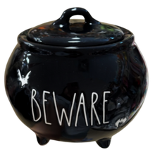 Load image into Gallery viewer, A glossy black cauldron-shaped ceramic container with a lid, featuring the word 'BEWARE' in white lettering and small white bat silhouettes, shown on a plain white background.

