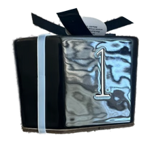 Load image into Gallery viewer, A square black glossy front panel featuring a large number 1, tied with a black ribbon.
