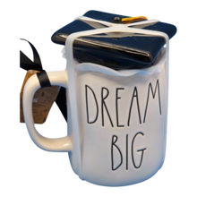 Load image into Gallery viewer, White mug that reads 'Dream Big' with a black lid that is shaped like a graduation cap.
