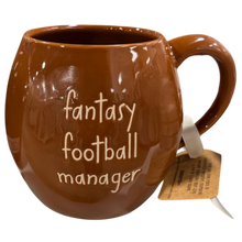 Load image into Gallery viewer, A glossy brown ceramic mug with the words 'fantasy football manager' printed in white script on the front, shown against a plain white background with a paper tag attached to the handle.
