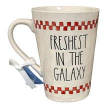 Load image into Gallery viewer, Mug with 'Freshest in the Galaxy' text and checkered pattern on a white background

