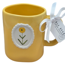 Load image into Gallery viewer, Yellow mug with floral circle  design and a tag on a white background
