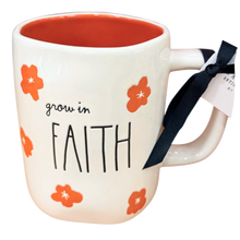 Load image into Gallery viewer, An off-white ceramic mug with an orange interior, decorated with orange flowers and the words 'grow in FAITH' in black. A black ribbon is tied to the handle, and a white paper tag is attached.

