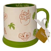 Load image into Gallery viewer, White mug with Lion King print that has a green bottom, handle and inside and says ' hakuna matata' on the inside.
