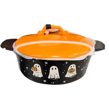 Load image into Gallery viewer, A Halloween-themed oval casserole dish with a matching lid, featuring a black exterior decorated with white ghosts and stars, and a bright orange lid and handle.
