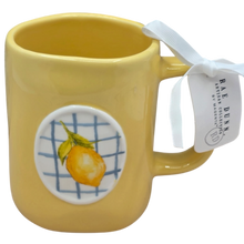 Load image into Gallery viewer, Yellow mug with lemon design with blue checkered print and Rae Dunn tag.
