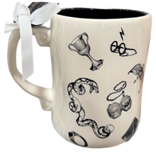 Load image into Gallery viewer, An off-white ceramic mug with black illustrations of Harry Potter symbols, including a goblet, lightning bolt glasses, snake, key, and a skull, featuring a white ribbon bow on the handle.
