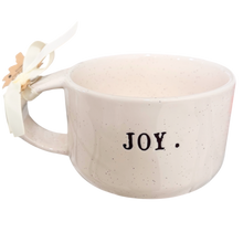 Load image into Gallery viewer, A speckled cream ceramic mug with the word 'JOY.' printed in black on the front, decorated with a white ribbon and a small paper flower on the handle, set against a plain white background.
