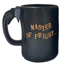 Load image into Gallery viewer, A black ceramic mug with the words 'MASTER OF FRIGHT.' printed in orange on the front, shown against a plain white background.
