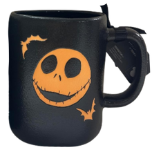 Load image into Gallery viewer, A black ceramic mug featuring a Jack Skellington face graphic in orange, with small orange bats, shown on a plain white background.
