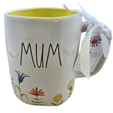Load image into Gallery viewer, White mug with 'MUM' text and floral designs, featuring a tag on a white background
