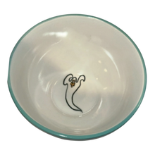 Load image into Gallery viewer, A white ceramic bowl with a thin teal rim and a small black ghost illustration with a yellow detail in the center, shown against a plain white background.
