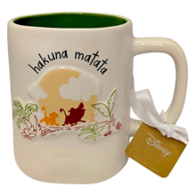 Load image into Gallery viewer, White mug with green inside that says 'hakuna matata' with an artistic image of the song from the Disney movie The Lion King.
