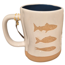 Load image into Gallery viewer, Ceramic mug with 3 fish designs on a white mug with tan bottom and navy blue interior.
