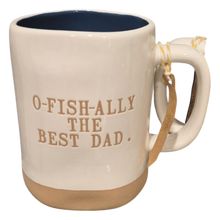 Load image into Gallery viewer, Mug with 'O-FISH-ALLY THE BEST DAD' text on a cream white mug with tan bottom and navy blue interiror.
