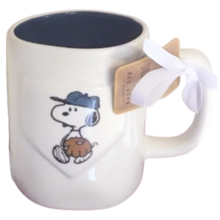 Load image into Gallery viewer, White mug with Snoopy cartoon character design dress like a baseball player and a tag, on a white background with blue interior.
