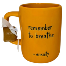 Load image into Gallery viewer, Orange mug that says 'remember to breathe - anxiety' on the front in black font.
