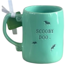 Load image into Gallery viewer, A mint green ceramic mug with 'SCOOBY DOO.' and bat silhouettes printed on the front, featuring a white ribbon tied to the handle.
