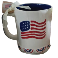 Load image into Gallery viewer, White mug with American flag design, blue interior and bottom flag banner design on a white background
