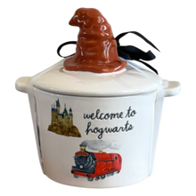 Load image into Gallery viewer, A white ceramic Harry Potter 'Welcome to Hogwarts' lidded container with a brown witch hat topper, black ribbon, castle illustration, and red train graphic on a white background.
